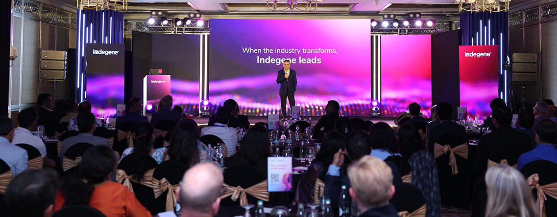 Indegene leadership addressing colleagues at a company event